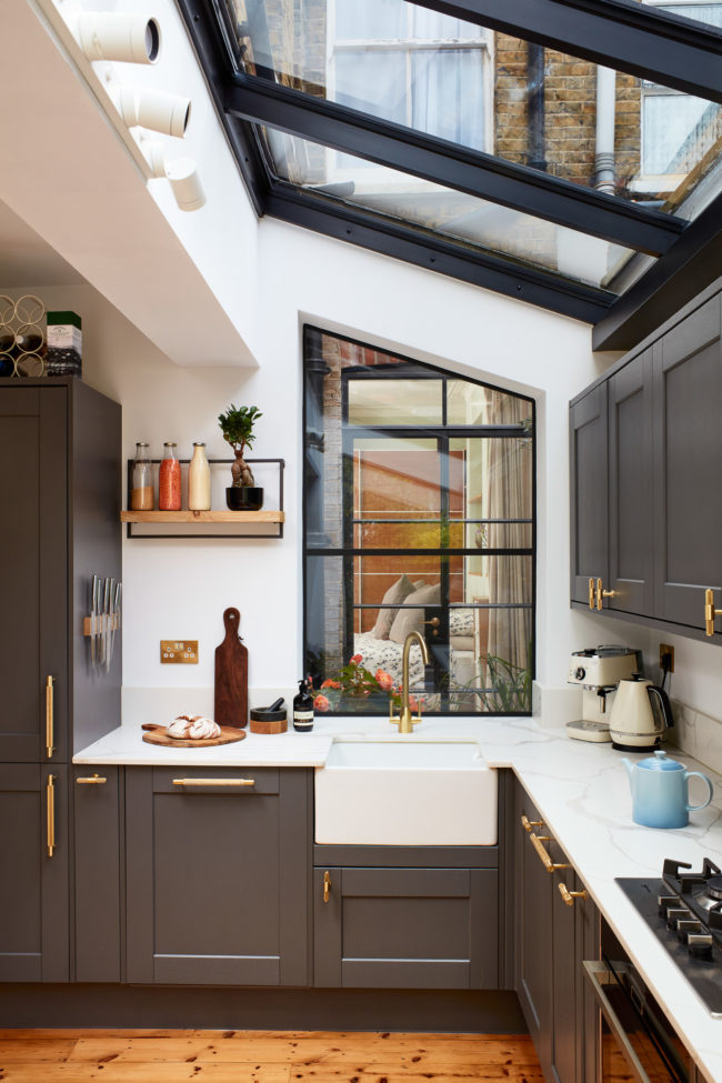 Interiors of refurbished south london appartment, kitchen with grey work units and wooden floor